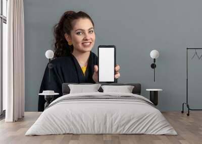 emotional young woman showing smartphone with empty touch screen with copy space Wall mural