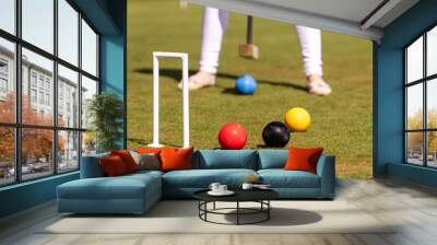 female croquet player hitting the ball with mallet Wall mural