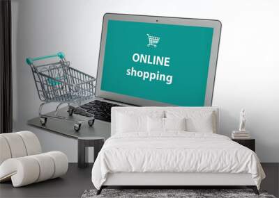 miniature shopping cart on laptop, isolated on light background Wall mural