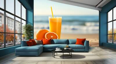 Orange juice on the beach. Background with selective focus and copy space Wall mural