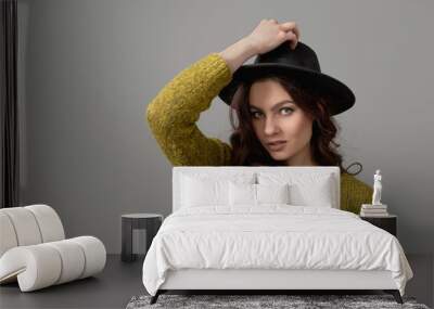 portrait of elegant beautiful woman in hat isolated on gray background Wall mural