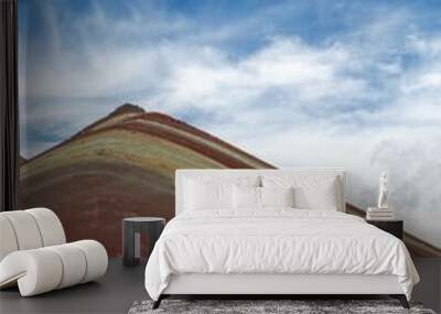 Vertical shot of the Vinicunca Rainbow Mountain on cloudy sky background Wall mural