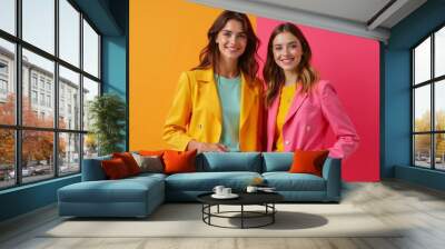 Colorful fashion duo: women in bright blazers against vibrant background Wall mural