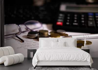 Coins and calculator, pen and glasses to sign a contract Wall mural