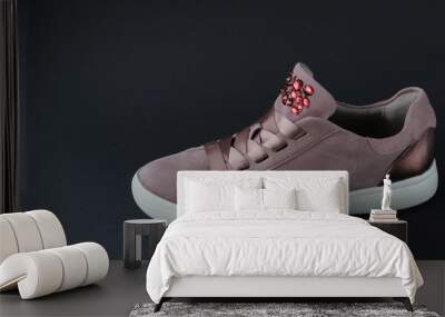 Pink sneakers with jewelry stones on black background Wall mural