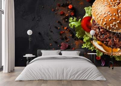 A classic hamburger made with lettuce, tomatoes, and cheese, served on a black background. This staple food is a popular fast food choice, combining natural ingredients on a bun Wall mural