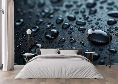 A close-up of water drops, liquid, or moisture on a black surface, showcasing the beauty of tiny droplets. Wall mural