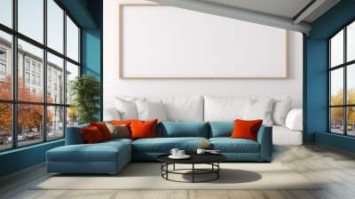 A cozy living room with a grey couch and a rectangular picture frame on the wall, showcasing modern interior design and comfortable furniture Wall mural