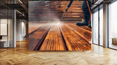 A man cleans a wooden terrace with a powerful high-pressure cleaner. Wall mural