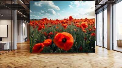 A mesmerizing natural landscape with red poppies against cloudy sky, surrounded by lush green grass and cumulus clouds. Wall mural