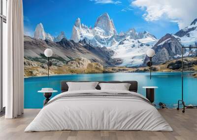 A turquoise lake in the forefront with a glacier clad mountain peak in the background against a blue sky Wall mural