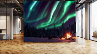 A warm and cosy campfire in the wilderness with forest trees silhouetted in the background and the stars and Northern Lights (Aurora Borealis) lighting up the night sky. Photo composite. Wall mural