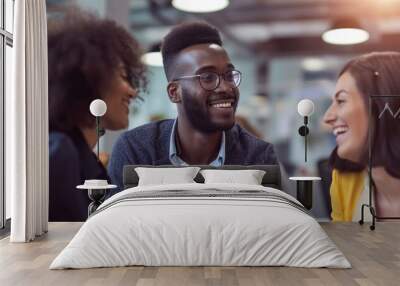 African American man consulting with a tour manager while a hipster woman smiles at her male colleague in an office. Wall mural