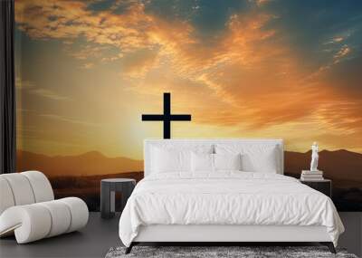 Artistic silhouette of a crucifix cross against a sunset sky showcasing mountain majesty Wall mural