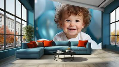 At the birthday party, the child's face lit up with joy as they saw the adorable baby dressed in a white outfit, surrounded by cute blue balloons and a perfectly lit cake. It was a portrait of happy Wall mural