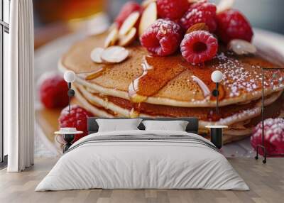 Close up of a stack of pancakes topped with raspberries almonds and maple syrup on a white plate Traditional breakfast dish Wall mural