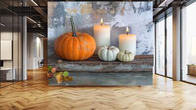 Creative autumn decor with pumpkins and candles on a rustic background Wall mural