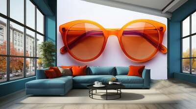 Fashion and healthcare idea Orange sunglasses with brown orange plastic frame on white background Wall mural