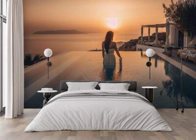 In Greece, an elegant woman in a white dress relaxes by the pool as the sun sets over the Aegean Sea. Generative AI Wall mural