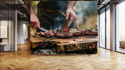 Man grills steak on wooden board outdoors for a summer picnic. Wall mural