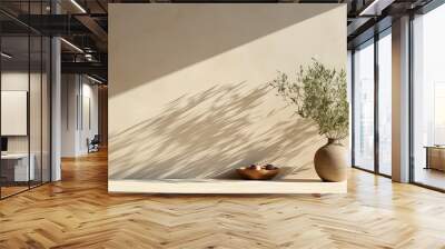 Minimal summer interior with olive tree on table under sunlight casting long shadows on beige wall Mediterranean vibe Wall mural