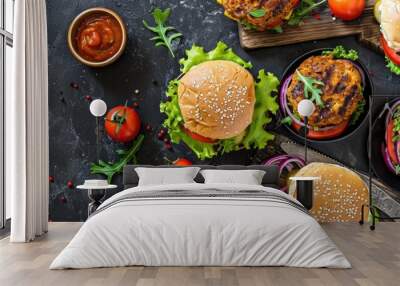 Overhead view of sandwiches with chicken burger hamburger and green salad Wall mural