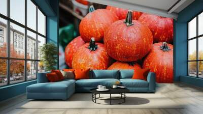 Pumpkin fruits stacked for sale in a local market with a focus on raw food backgrounds from an elevated perspective Wall mural