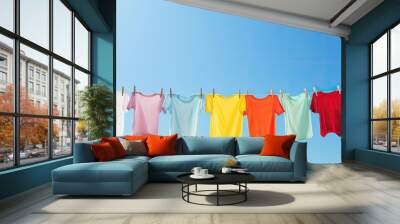 sun and blue sky backdrop with t shirts on clothesline Wall mural