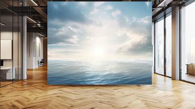 Sunlight shines on the ocean amidst cloudy skies. Wall mural