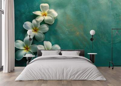 Three frangipani blossoms on a green surface Wall mural