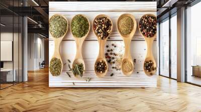 Top view closeup of assorted spices in bamboo spoons on white wooden surface Wall mural