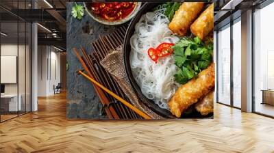 Top view of Asian food: Cold rice vermicelli with sauce, paired with fried spring rolls in a bowl. Wall mural