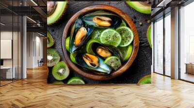 Top view of raw kiwi mussels with lime and kiwi in a wooden bowl Wall mural