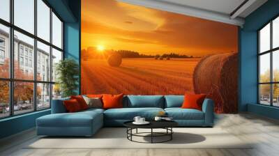 Two bales of hay are seen in a field as the sunset casts an orange glow, creating a perfect autumn wallpaper or montage backdrop. Wall mural