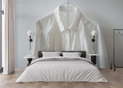 White blouse or shirt on hanger against white background close up shot with blank space Wall mural