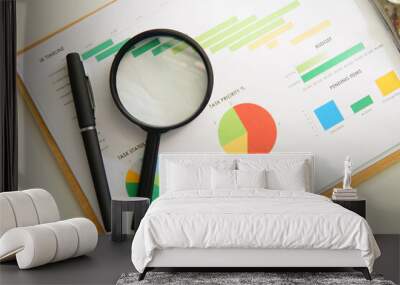 Magnifying glass and pen over graph on table. Financial concept. Business Wall mural