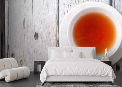 A cup of tea over weathered wooden background Wall mural