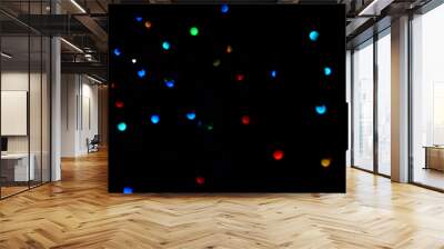 Glowing lights on the ceiling isolated on a black background Wall mural