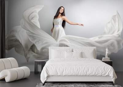 beautiful young girl in flying white dress. Flowing fabric. Light white cloth flying in the wind Wall mural