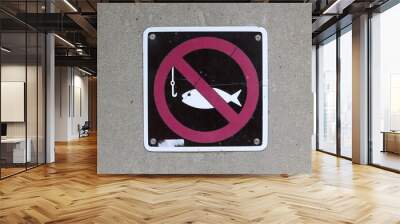 A close view on the no fishing sign on the cement wall. Wall mural