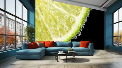 Close-up of a lime slice with bubbles on a black background Wall mural