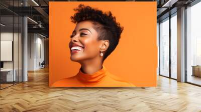 Beautiful, sexy, happy smiling dark-skinned African American woman with perfect skin and short haircut, on an orange background, banner. Wall mural