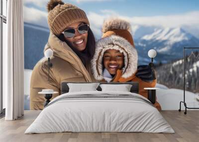 Happy, smiling, afro american family mother with daughter snowy mountains at ski resort, during vacation and winter holidays. Wall mural