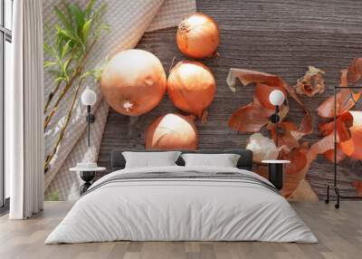 onions, linen towel and blossomed willow are on the surface of the wooden table. Wall mural