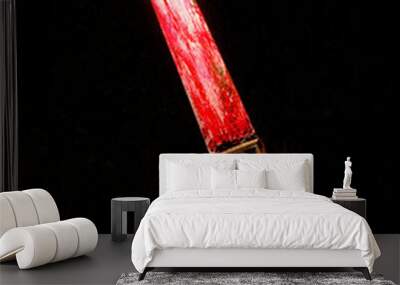 Bloody knife with yellow label on black background Wall mural