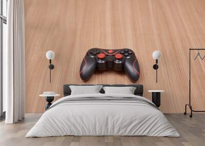 red gamepad with a wooden background Wall mural