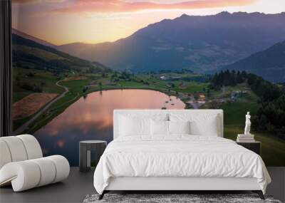 Aerial view at sunrise of lake Wolfsee in Fiss (Tirol, Austria) in summer, on the background the Austrian alps Wall mural