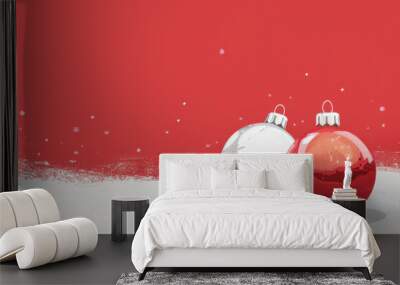 Two Christmas ornaments, red and white, resting on snow with a festive background of falling snowflakes. Wall mural