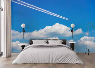 Beautiful storm clouds, cumulus clouds or cumulonimbus against a clear blue sky with an airliner with contrails. Photography, Full frame. Wall mural