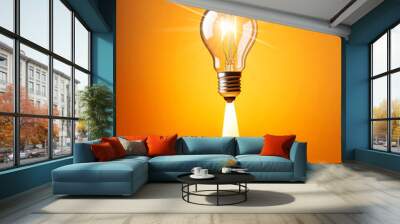 Close-up of a light bulb taking off and releasing smoke like a rocket against a yellow-orange background with copy space. Idea explosion, startup, big ideas and leadership concept. Generative Ai. Wall mural